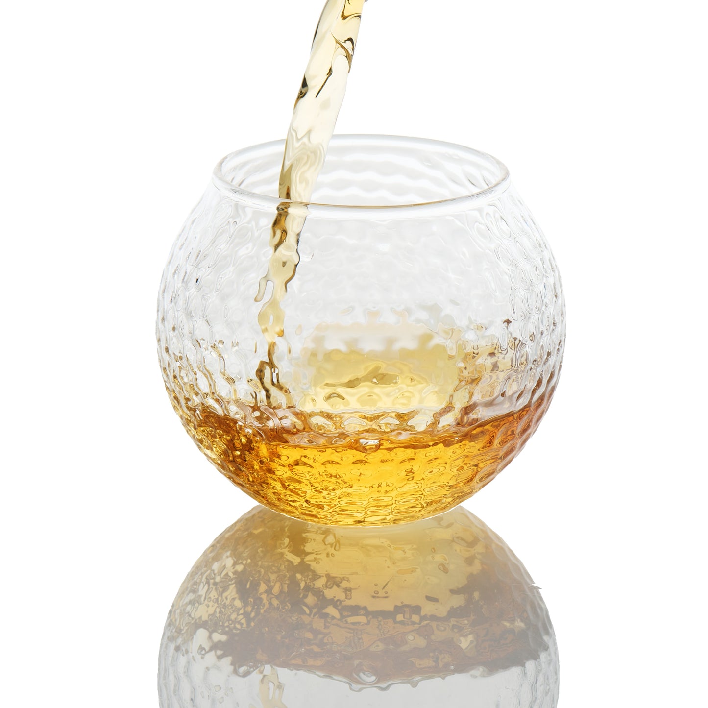 Luxury whiskey glass inspired by a golf ball design