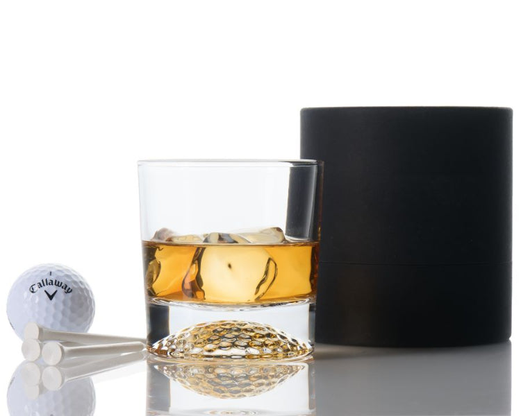 Luxury golf-inspired whiskey glass with a sculpted golf ball base. Choose a single glass or a complete gift set for golfers.