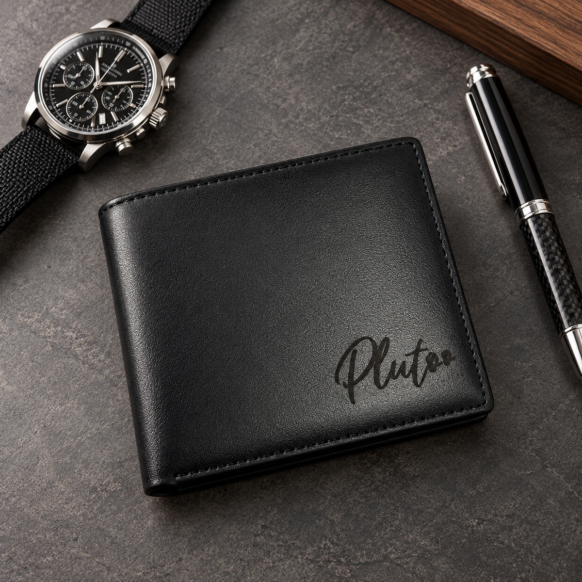 Personalized black leather bifold wallet for men with Pluto name engraving and paw prints, displayed on a luxury matte charcoal desk beside a black watch and pen. The lighthouse goods