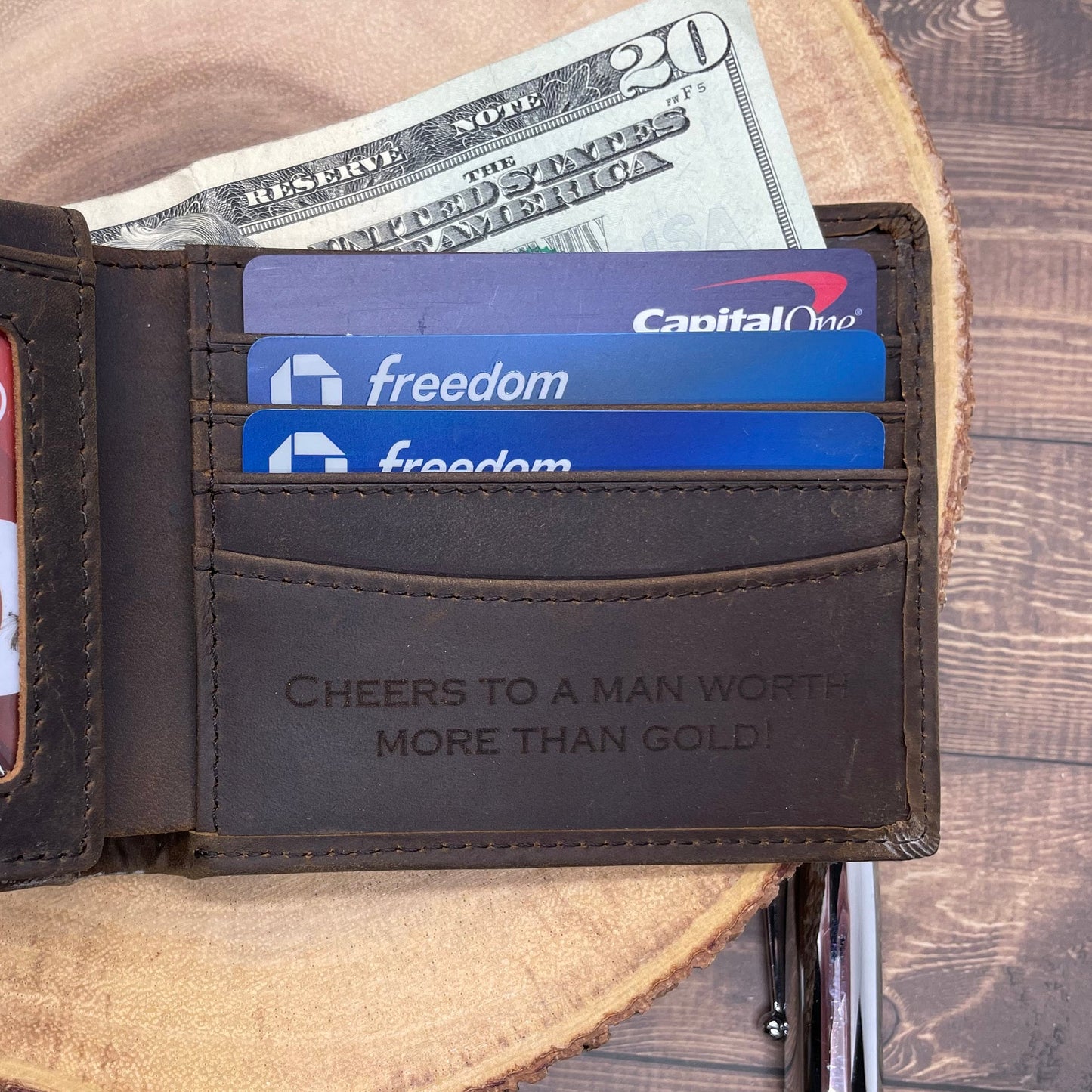 Open wallet with money and cards on a wooden surface